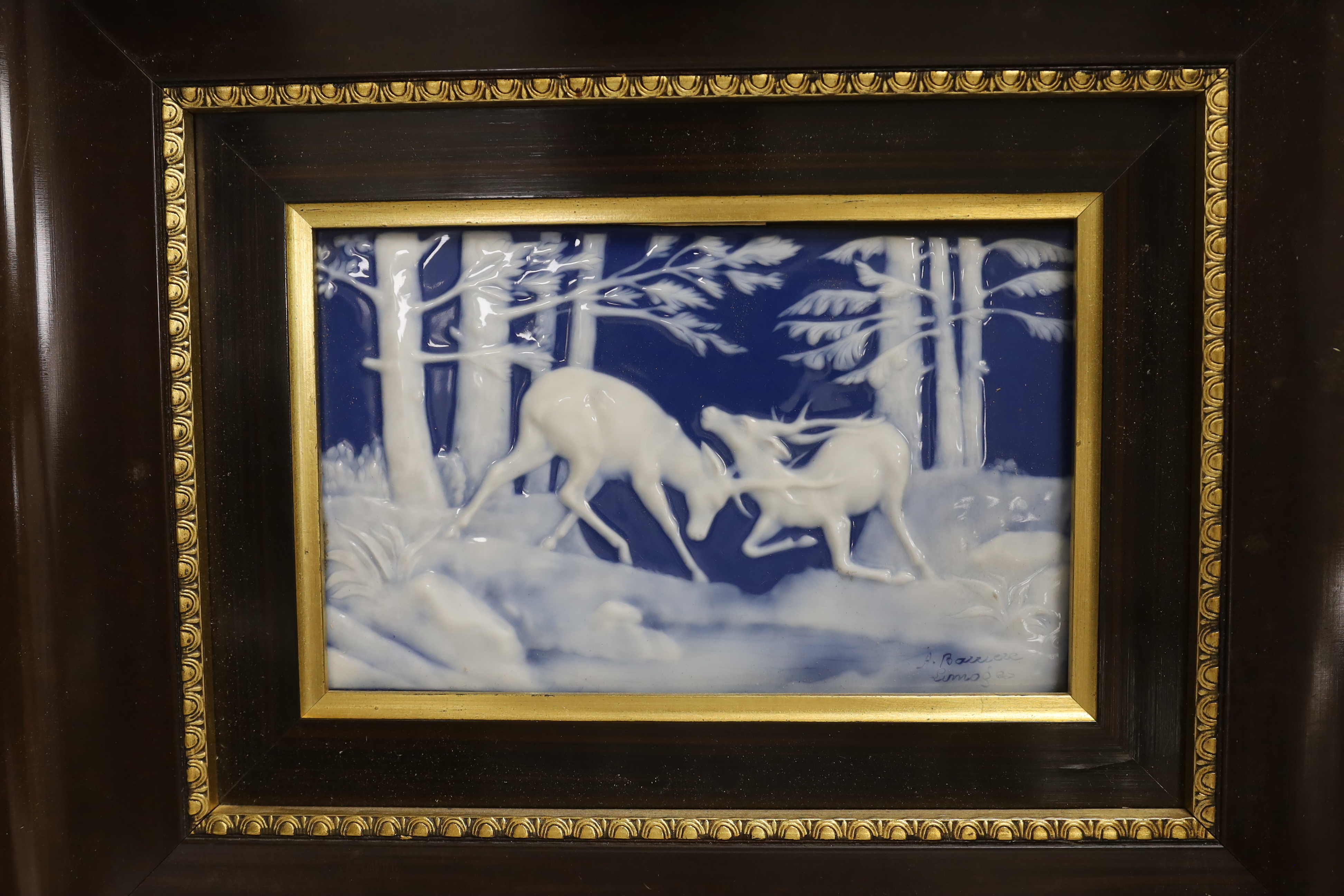 A framed Limoges Pate Sur Pate plaque depicting stags fighting, signed Barriere, 34 x 42cm including frame